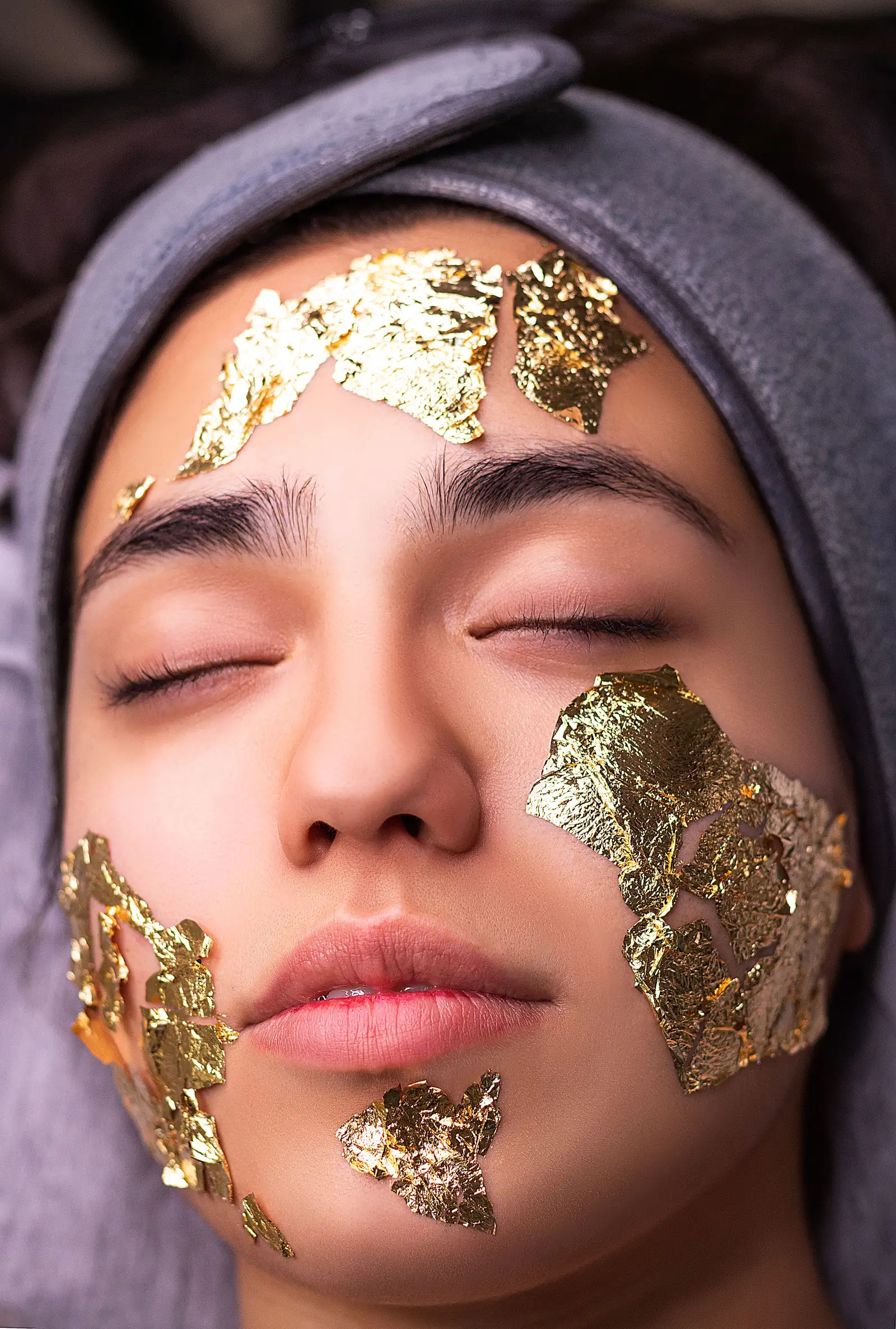 A gold-leaf facial mask detail