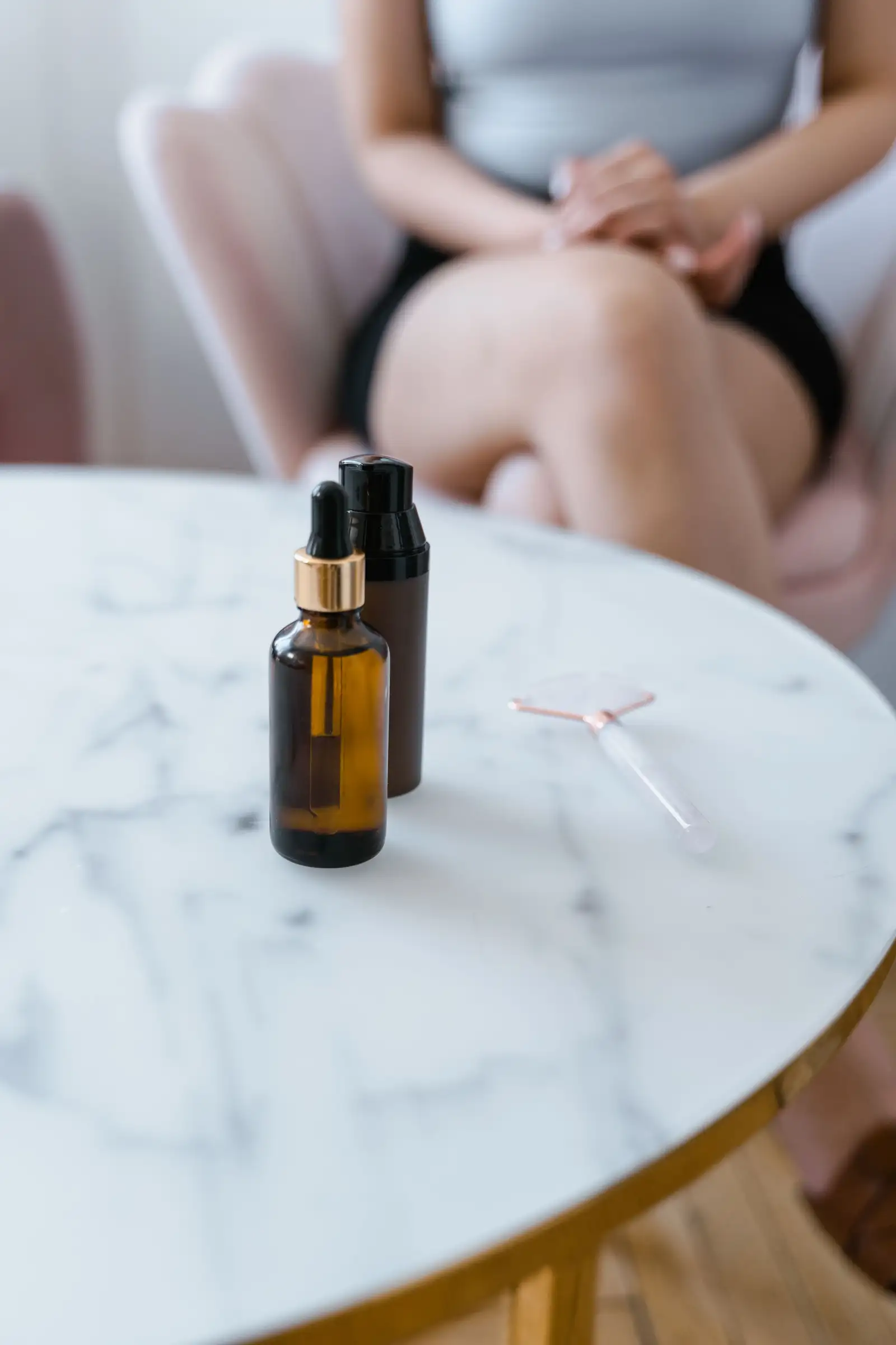 Skincare bottles arranged on marble